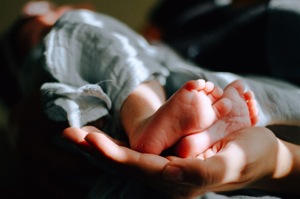 parent holding babys feet
