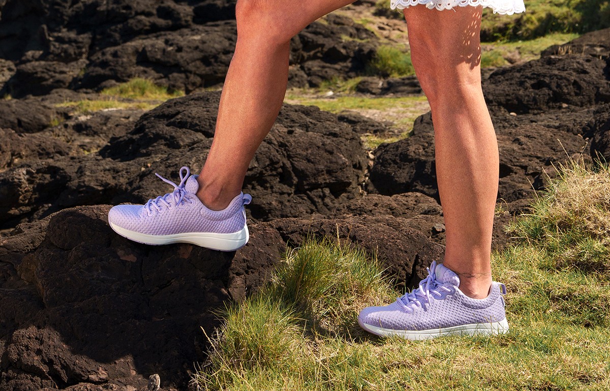 Woman walking in nanture wearing Footactive's Green Steps ONE orthopedic trainers for women 